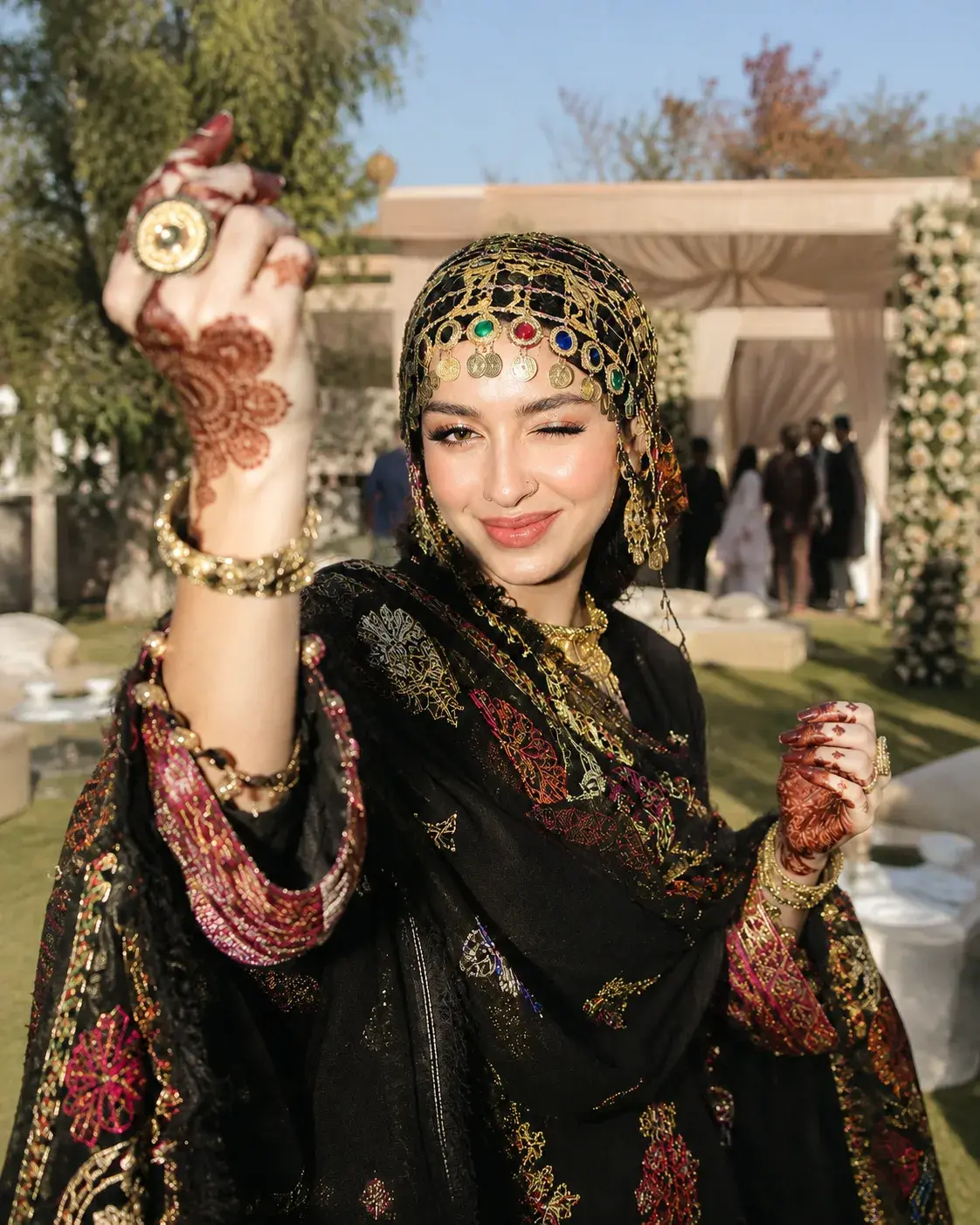 Shopper in an embroidered black shawl and gold headpiece