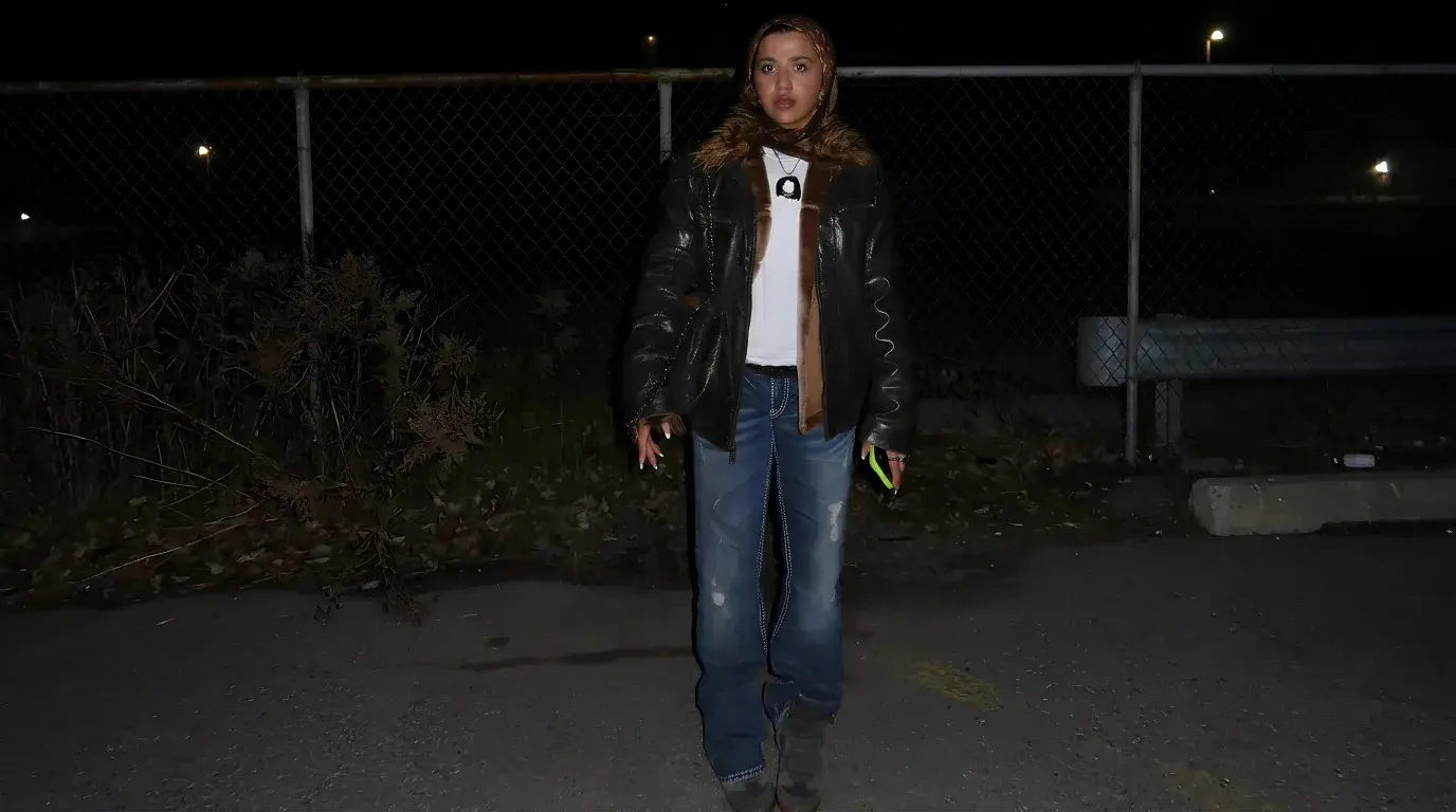 Creator in a shearling jacket and fur-trimmed hijab at night